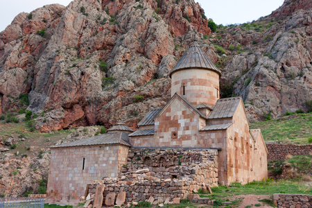 Armenian Surb Karapet church in Noravank with red mountains behindの写真素材