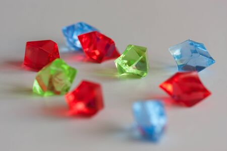 Closeup colorful crystals isolated on light background - focus on greenの写真素材
