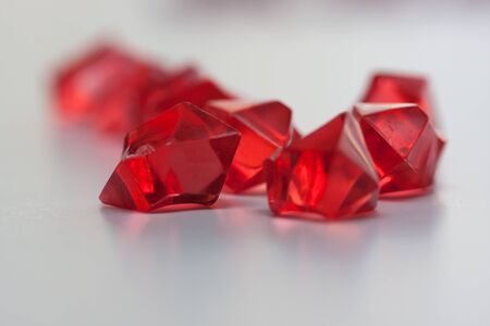 Closeup red crystals isolated on light backgroundの写真素材