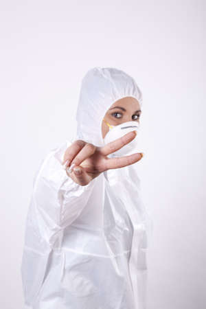 Young lab technician showing peace signの写真素材