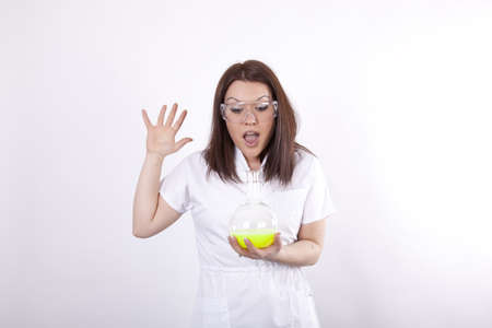 Beautiful young female laboratory technician with test tube in her handの写真素材