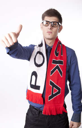 Man wearing Poland scarf and showing thumb up.の写真素材