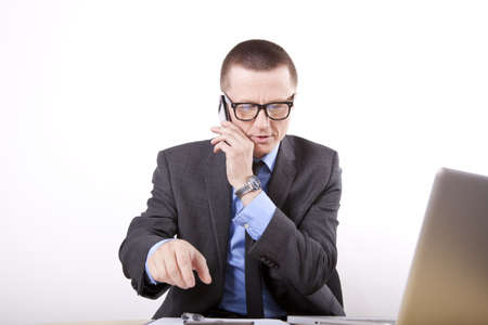 Young business man talking on a phone.の写真素材