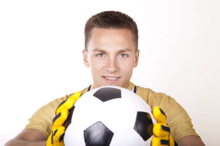 Young man goalkeeper holding a ball.の写真素材