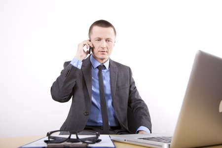 Portrait of a successfull young business man talking on a phone.