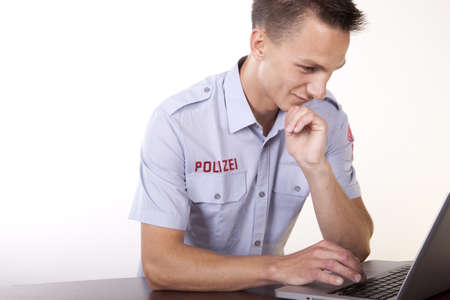 Portrait of a young attractive male policeman working.