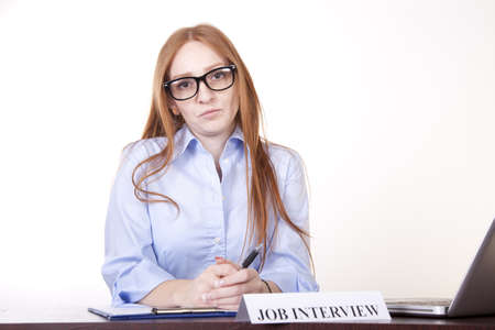 Portrait of a young attractive female secretary with a sign job interview.の写真素材