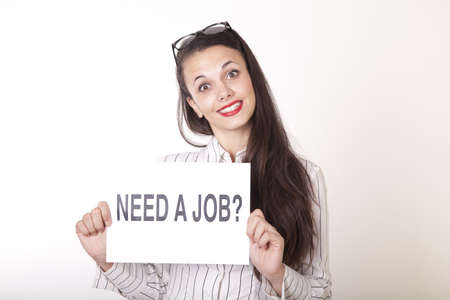 Portrait of a young beautiful woman holding a sign need a job.の写真素材