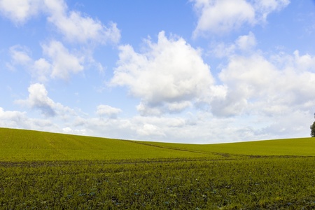 silhouette of a light hill against a blue cloudy sky.の写真素材