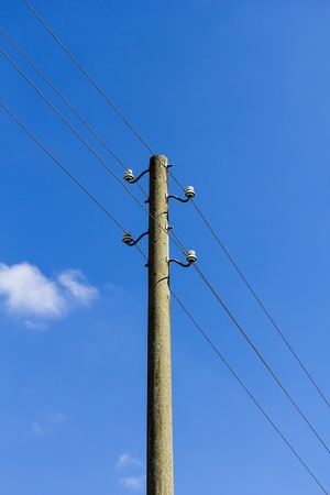 old concrete power-line isolated on blue sky.の写真素材
