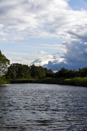 dramatic sky on a lake in summer の写真素材