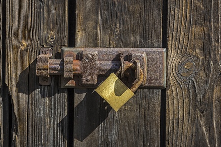 Old key lock on wooden door  の写真素材