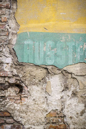 Old brick wall pattern closeup with fragments of letters,の写真素材