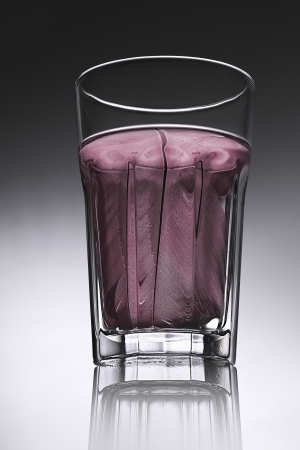 simple water-glass with structured water in red.の写真素材