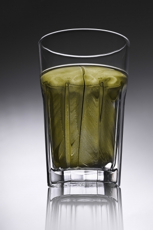 simple water-glass with structured water in yellow.の写真素材