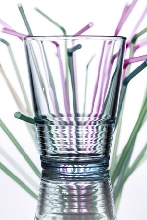 water glass with straws in the background の写真素材