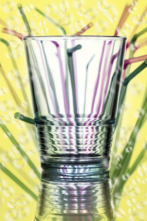water glass with straws in the background の写真素材
