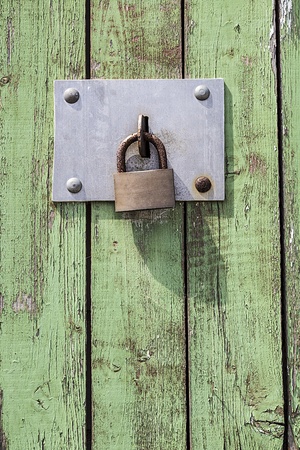 Old key lock on wooden door .の写真素材