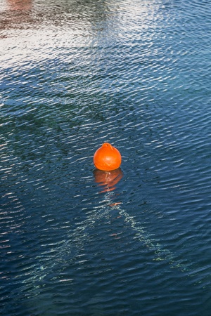 orange buoy in blue ocean water の写真素材