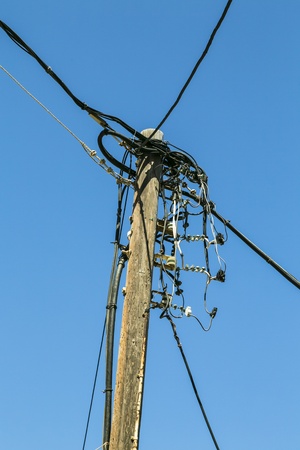 old wooden powerline, isolated on blue sky の写真素材