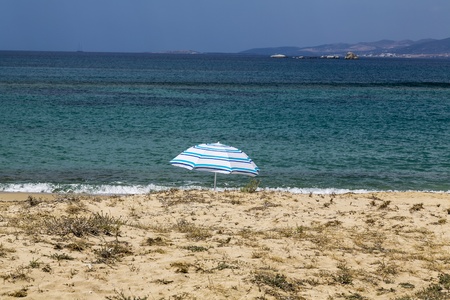 single parasol at beach with turquoise ocean の写真素材