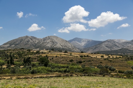 greek landscape with meadow, mountain and blue sky の写真素材