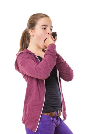 bored teenage girl speaking on mobile phone, yawning, isolated on white.の写真素材