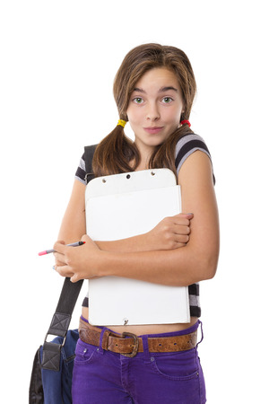 teenage girl with clipboard and pencil smiling, isolated on white.の写真素材