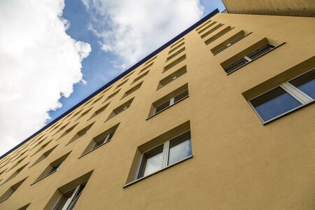 extreme perspective of a yellow house wall with blue sky.の写真素材