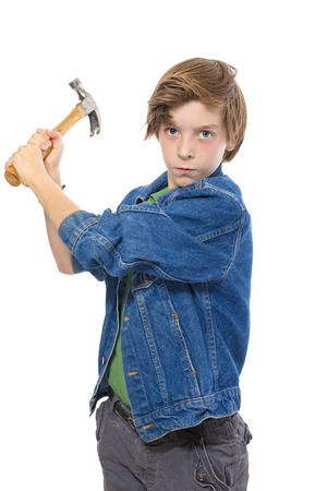 teenage boy holding a hammer ready to hit, isolated on whiteの写真素材