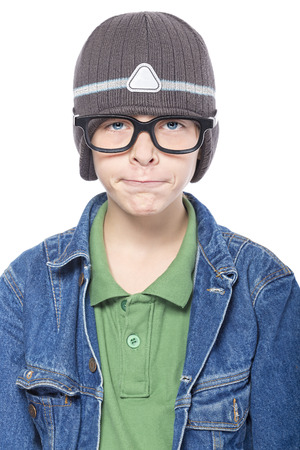playful teenage boy makes strange gestures, isolated on white.の写真素材