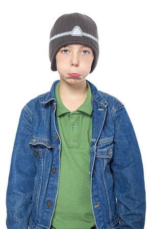 portrait of a sulking teenager boy with cap, isolated on white.の写真素材