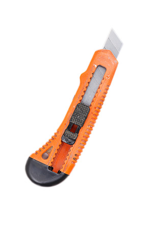 an old used orange box knife, isolated on white.の写真素材