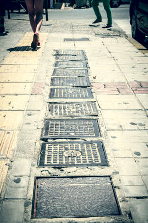 vintage style photo of some gully covers.の写真素材