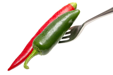 green and red hot chili on a fork, isolated on white.の写真素材