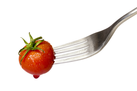cherry tomato spiked by a fork with a drop of blood, isolated on white.の写真素材