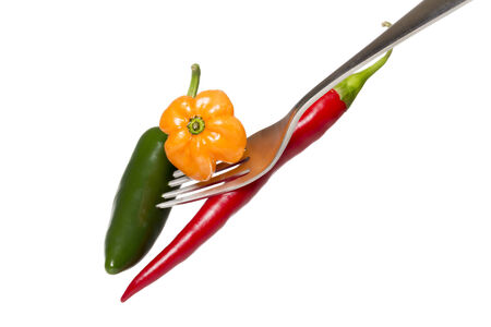 some hot chili on a fork, isolated on white.の写真素材