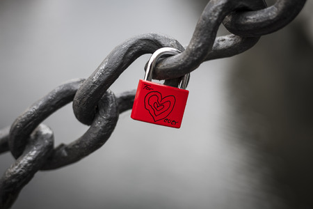red padlock hanging on a big chain with heart and the words for ever.