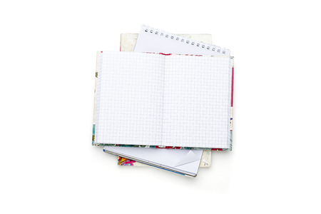 stack of some open blank note pads and books, isolated on white.の写真素材