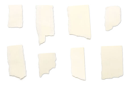 ripped yellow pieces of paper, isolated on white.の写真素材