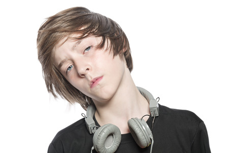 moving cool teenager boy with headphones, isolated on white.の写真素材