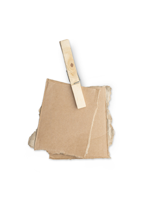 stack of ripped pieces of card board, holding together of a clothespin, isolated on white.の写真素材