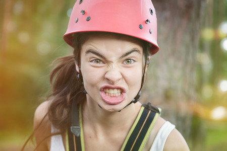furious teenager girl with red climber helmet.の写真素材