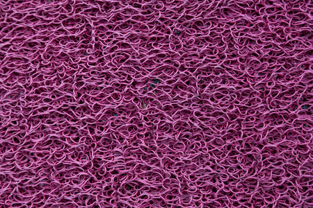 macro of a dark pink plastic carpetの写真素材
