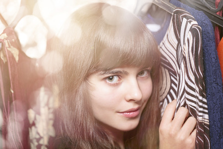 portrait of a beautiful teenage girl and her wardrobe, with bokehの写真素材