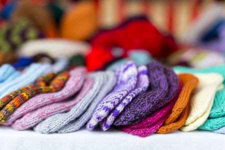 a  row of multicolored hand-knitted baby socksの写真素材