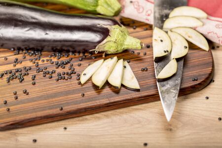 still life with cutted eggplant slices, kitchen knife