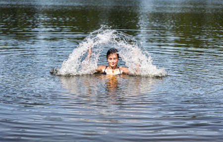 swimming woman makes a water fountain