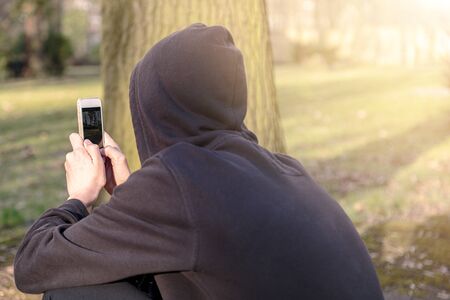 teenage boy taking photographs with a smart phoneの写真素材