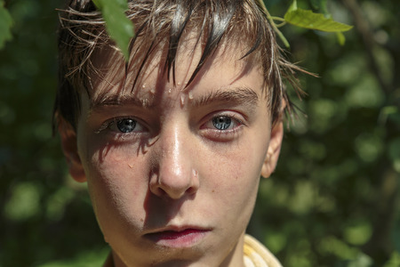 portrait of a teenage boy after swimming in summer